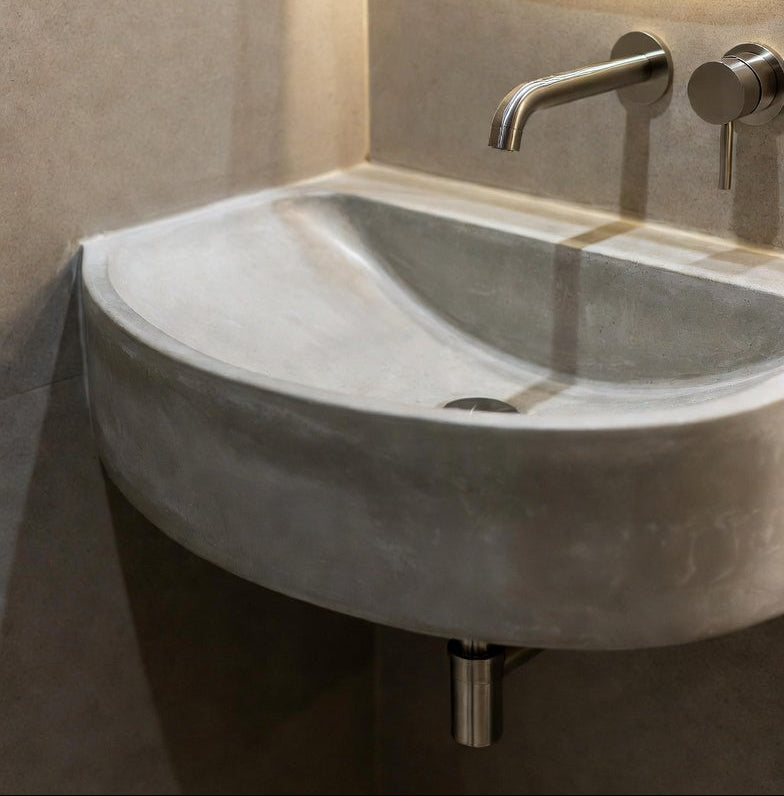 Corner sink with faucet in a bathroom setting